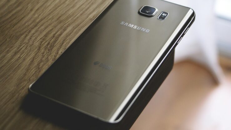 A sleek Samsung smartphone placed on a wooden surface, capturing modern elegance.